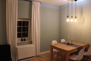 a dining room with a table and white chairs at City Apartment Schladming in Schladming +6 photos