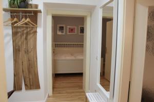 a room with a bedroom with a bed and a mirror at City Apartment Schladming in Schladming