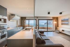 a kitchen and living room with a couch and a table at Tossa de Mar Beach in Tossa de Mar