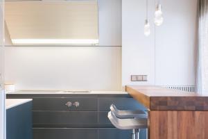 a kitchen with blue and white cabinets and a sink at Tossa de Mar Beach in Tossa de Mar +42 photos