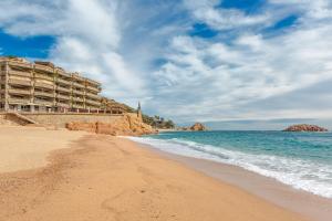 a view of a beach with a hotel at Tossa de Mar Beach in Tossa de Mar