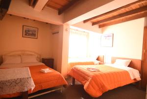 Rúm í herbergi á Tambo Cusco Inn