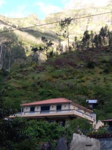 a large building with a view of the mountains at Danny's Rural Suite in Curral das Freiras