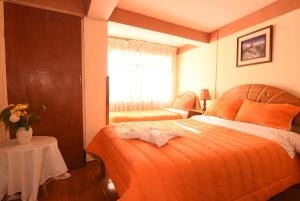 Rúm í herbergi á Tambo Cusco Inn