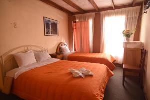 Rúm í herbergi á Tambo Cusco Inn