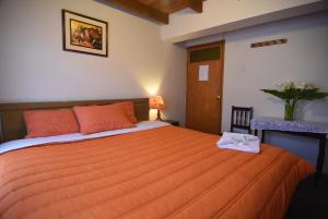 Rúm í herbergi á Tambo Cusco Inn