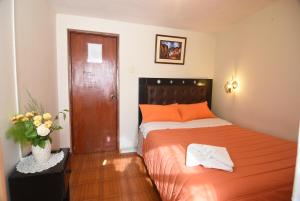 Rúm í herbergi á Tambo Cusco Inn