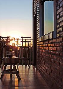 a patio with two chairs and a table and a window at HOTEL TRAVEL Encarnación in Encarnación