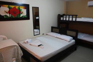 a bedroom with two bunk beds and a mirror at Hotel Boquilla Suites By GEH Suites in Cartagena de Indias
