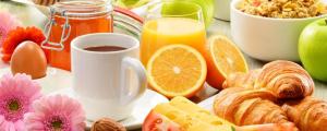 a table with a plate of breakfast foods and a cup of coffee at Camino House in Tralee