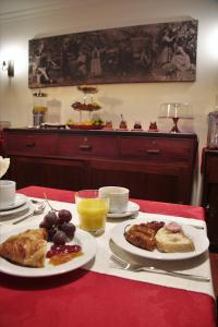 a table with plates of food on a red table at O Casario in Mirandela