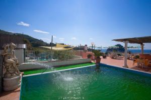 a swimming pool with a fountain in a yard at Hotel Residence S.Angelo in Ischia +37 photos
