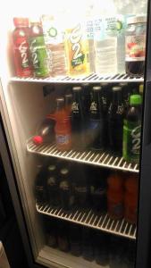 a refrigerator filled with lots of soda and drinks at Asia Novo Boutique Hotel - Daet in Daet