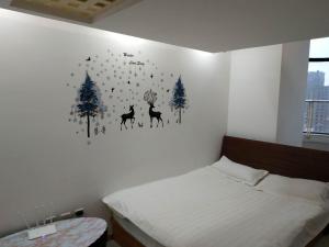 a bedroom with a bed with a picture of deer on the wall at Mayson Shanghai Bund Serviced Apartment in Shanghai