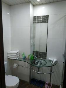 a bathroom with a sink and a toilet and a mirror at Mayson Shanghai Bund Serviced Apartment in Shanghai