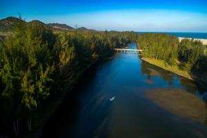 an aerial view of a river with a boat in it at Seava Ho Tram Beach Resort in Ho Coc