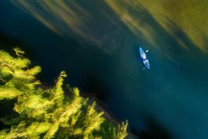 an aerial view of a boat in the water at Seava Ho Tram Beach Resort in Ho Coc