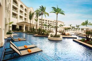 an image of a resort swimming pool with palm trees at Hyatt Zilara Rose Hall Adults Only - All Inclusive in Montego Bay