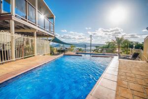 a swimming pool with a slide in a building at Airlie Apartments in Airlie Beach