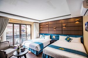 Giường trong phòng chung tại Mimosa Hotel Sapa