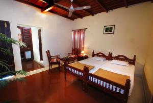 Postel nebo postele na pokoji v ubytování Agraharam Resorts