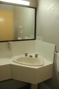 a bathroom with two sinks and a mirror at Childers Gateway Motor Inn in Childers