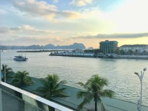a view of a river with a boat in it at Moc Tra Hotel Tuan Chau Hạ Long in Ha Long