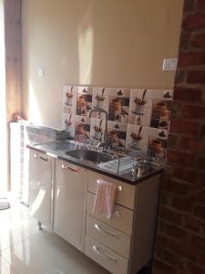 a kitchen with a sink and a counter top at Unik studio Apartments in Lusaka +13 photos