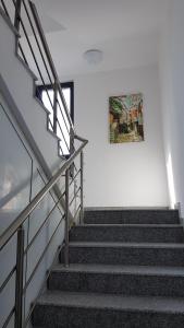 a set of stairs with a painting on the wall at Guesthouse Odesos in Sozopol