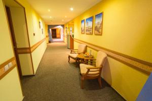 a hallway with chairs and a table in a room at Suite Hotel in Yekaterinburg