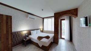 Postel nebo postele na pokoji v ubytování Patron Hotel