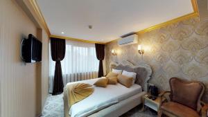 Postel nebo postele na pokoji v ubytování Patron Hotel