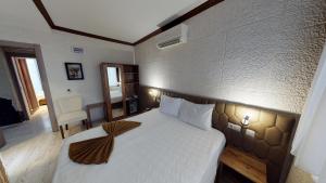 Postel nebo postele na pokoji v ubytování Patron Hotel
