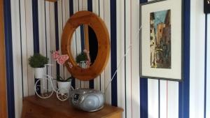 a mirror on top of a dresser in a room at Kilsborgs Gård - Lakehouse in Svanskog