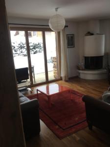 a living room with a table and a large window at Haus am Golfplatz in Selfranga