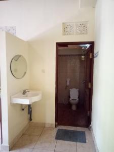 a bathroom with a sink and a toilet at Mimba Private House in Padangbai