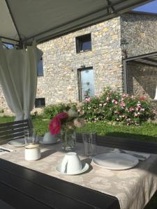 a table with plates and flowers on top of it at B&B Oca Nera Lerici in Lerici