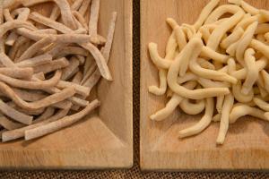 two wooden cutting boards with noodles on them at Agriturismo Colle Tocci in Subiaco