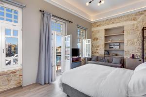 a bedroom with a large bed and a living room at 1924 suites in Chania