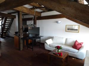 a living room with a white couch and a table at Altstadthotel Molitor in Bamberg