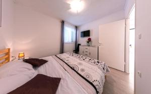 a bedroom with a large bed and a window at Apartment Nino in Skradin