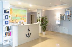 a salon with a white counter with a painting on the wall at Residenze Roscioli in Roseto degli Abruzzi