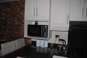 a kitchen with a counter top with a microwave at 11 Coral Sands in Scottburgh