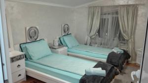 a small bedroom with two beds and a window at Hotel Paradise in Sofia