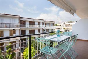 a balcony with a table and chairs on a building at Stay U-nique Apartments Sitges Beach in Sitges