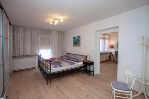 a bedroom with a bed and a table and chairs at Apartman Colosseum in Pula