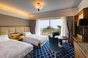 Letto o letti in una camera di Kawana Hotel