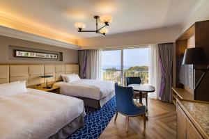 Postel nebo postele na pokoji v ubytování Kawana Hotel + 37 fotografií