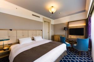 Letto o letti in una camera di Kawana Hotel