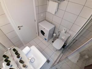 a white bathroom with a toilet and a sink at Olympia Zervea Studios with Pool - Apartment in Kardamili +40 photos